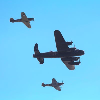 Battle of Britain Memorial Flight in formation against blue sky side on