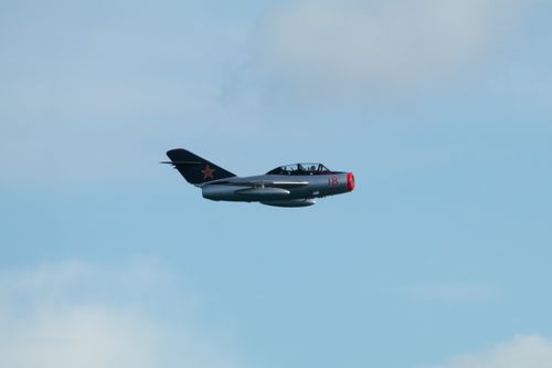 MiG-15 flying to right of frame agaist blue sky