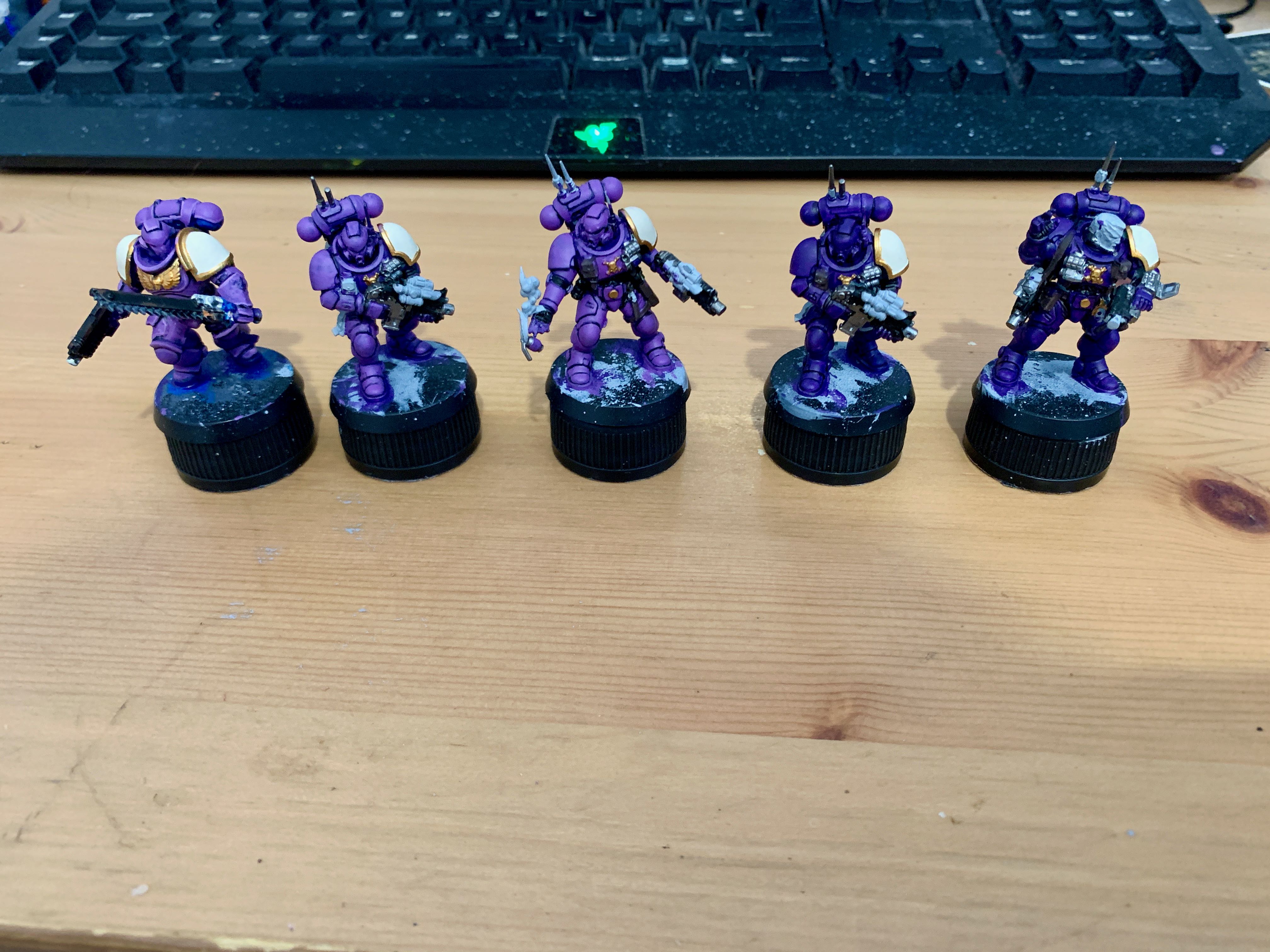 5 purple space marines in a line with in various shades of purple