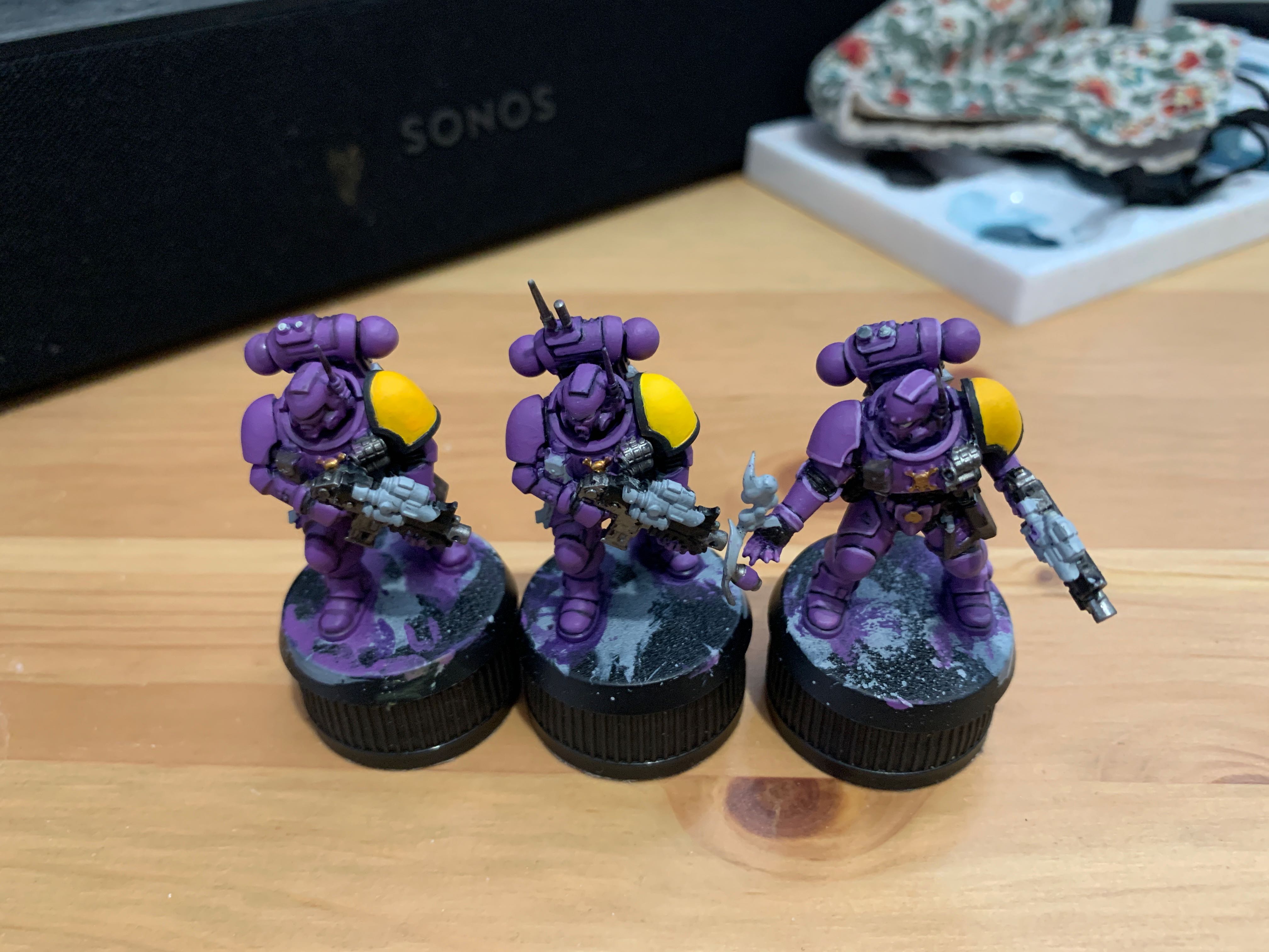 5 purple space marines with various shades of yellow on their shoulder pads