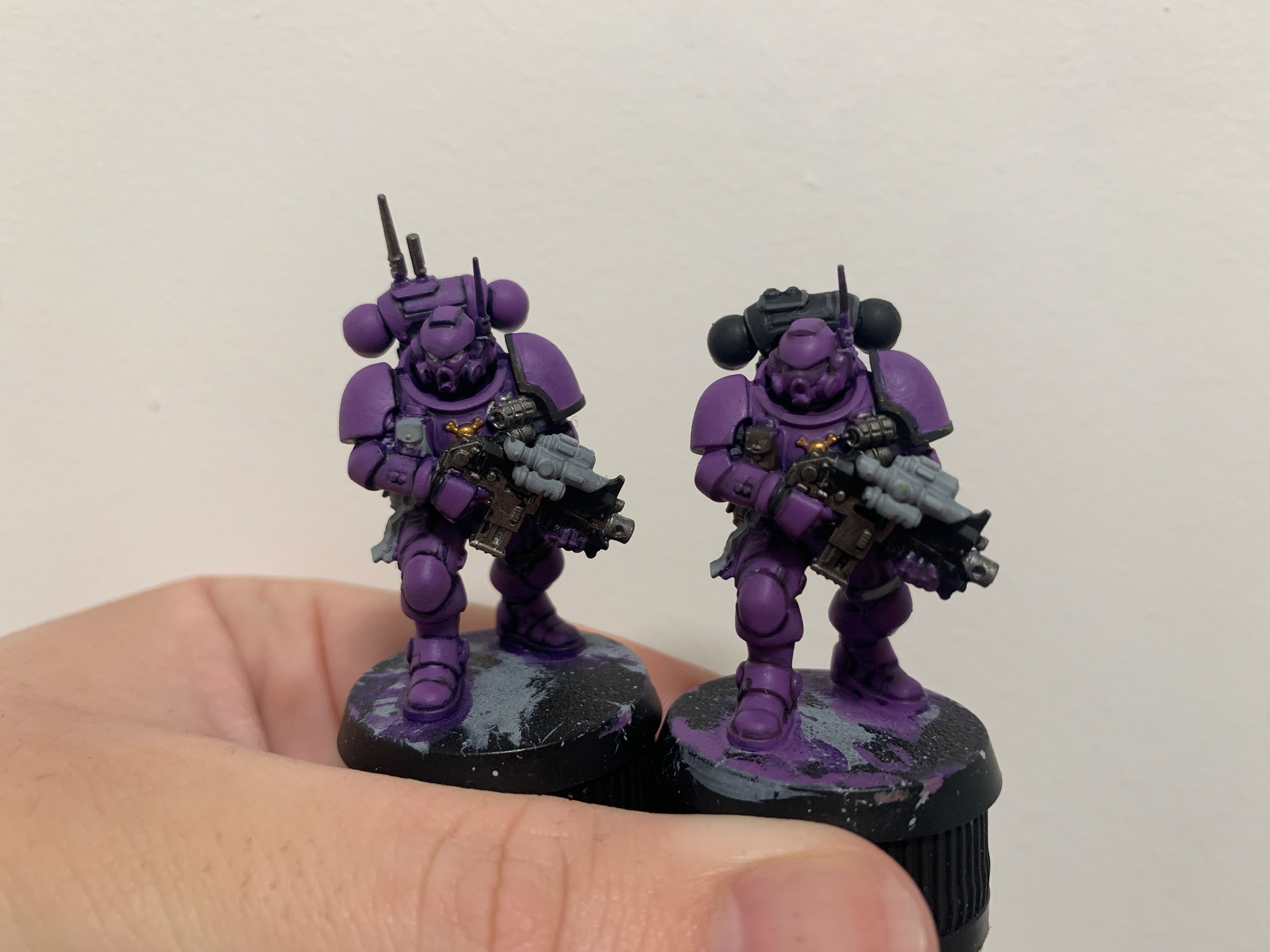 2 purple space marines. The one on the right has a black backpack