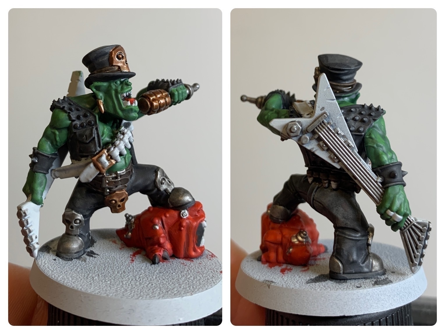 A front and rear shot of my half painted Goff Rocker Ork miniature.The ork is posed with one foot raised on a squig, their left arm holding a microphone up to sing into and the other holding a guitar that's strapped to their back. He is wearing biking leathers and a hat. I have painted most of the orks skin in a dark green with some highlighting and shadows. I have painted the leathers black. The squig is painted a bright red. The guitar is unpainted. Various metal accents are in a mix of bronze and silver colours