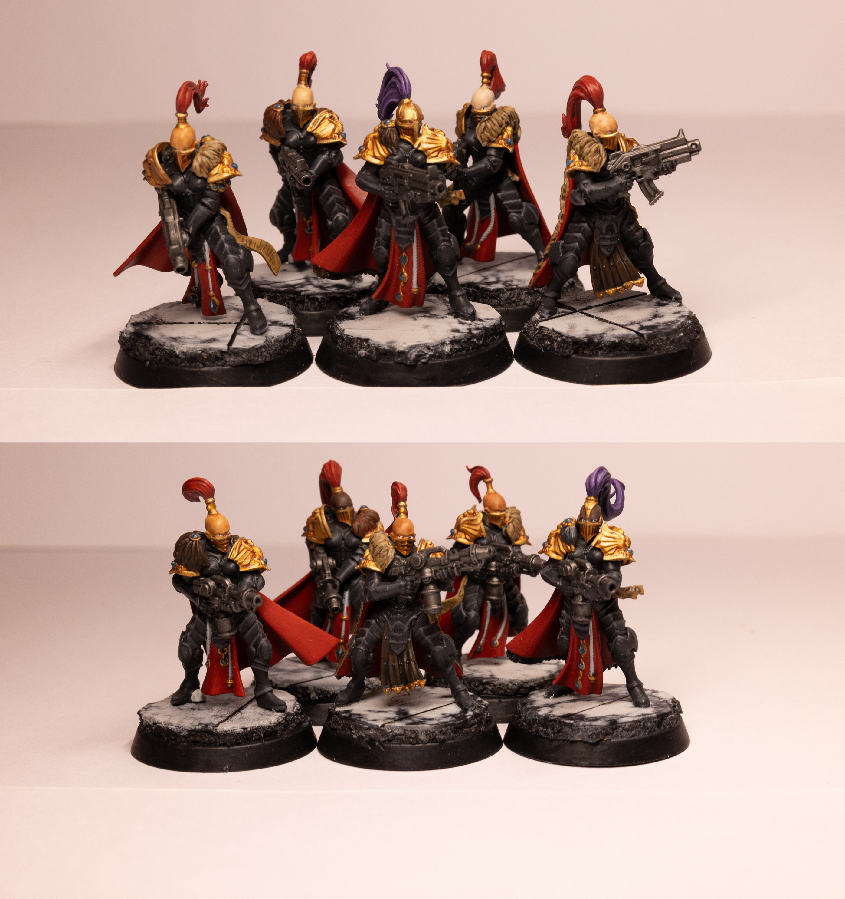 Ten Warhammer 40k Sisters of Silence in Shadowkeepers colour scheme. They are female warriors in black armour with gold trim and red capes/plumes. They are bald bar a long plume of hair in a top knot held in place with gold jewellery. Two of the plumes are purple. The are all stood on black and while, marble-like bases