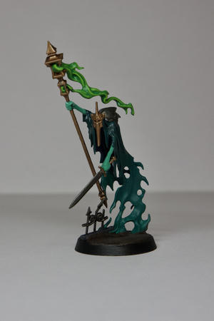 A blue-green ghost Warhammer model. His spectral form is a dark blue to green transition with his arms being a pale green. He has a brass helm and steel plates on his back. In one hand he is holding a steel sword and the other he his holding a tall brass lantern which green-yellow smoke billowing out. He is stood on on muddy base with some ironwork exposed 