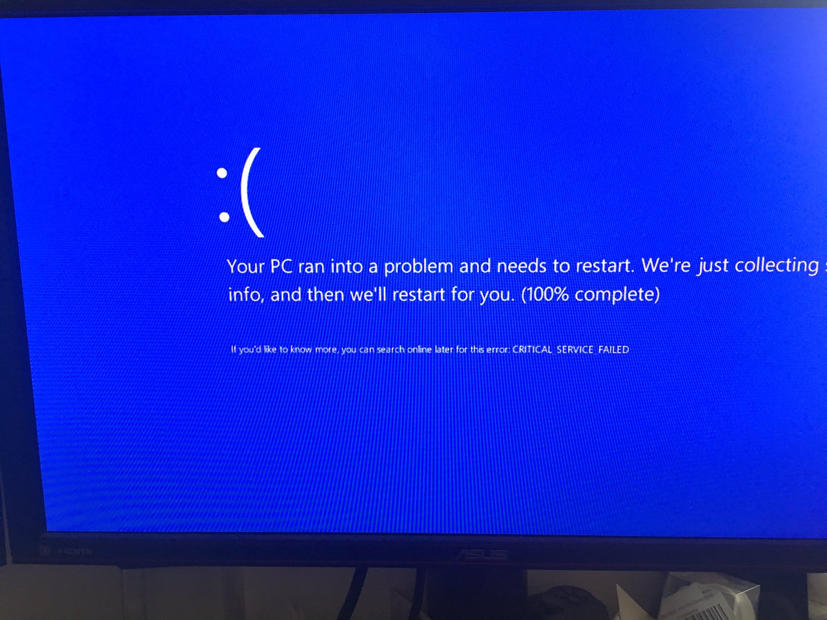 Photo of Windows 10 blue screen of death showing an unhappy face
